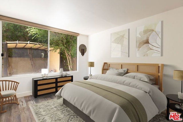 bedroom featuring hardwood / wood-style floors and multiple windows