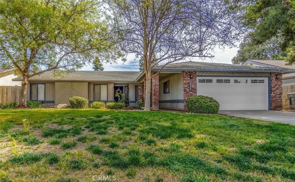 ranch-style house with a garage and a front yard