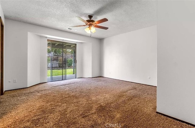 carpeted spare room with a textured ceiling and ceiling fan