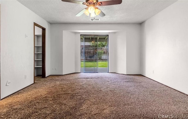 carpeted empty room with a textured ceiling and ceiling fan