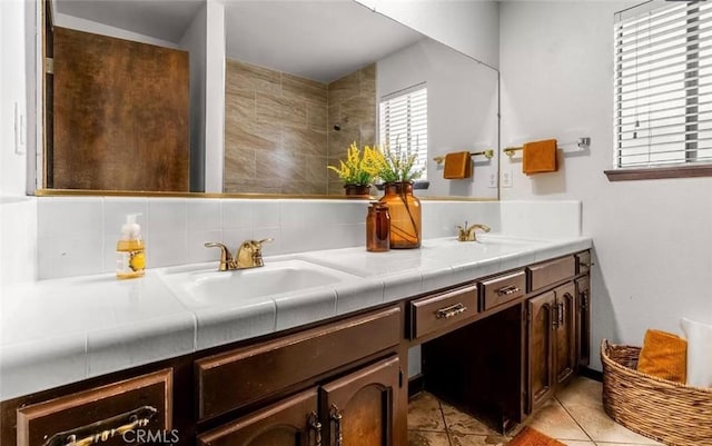 bathroom with vanity, tile patterned flooring, and tasteful backsplash