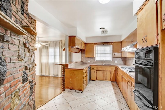 kitchen with dishwasher, sink, oven, light tile patterned floors, and gas cooktop