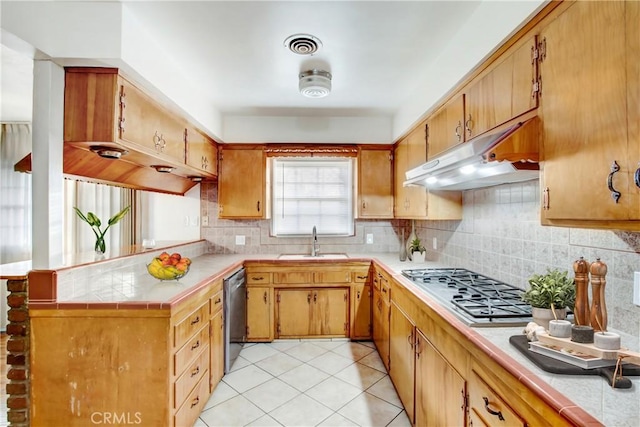 kitchen featuring appliances with stainless steel finishes, sink, light tile patterned floors, and backsplash