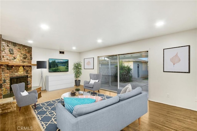 living room with hardwood / wood-style floors and a fireplace