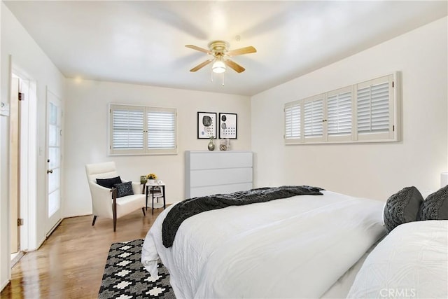 bedroom with ceiling fan and light hardwood / wood-style flooring