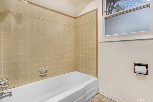 bathroom featuring tile patterned flooring and tiled shower / bath