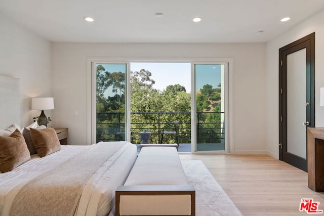 bedroom featuring light hardwood / wood-style flooring and multiple windows