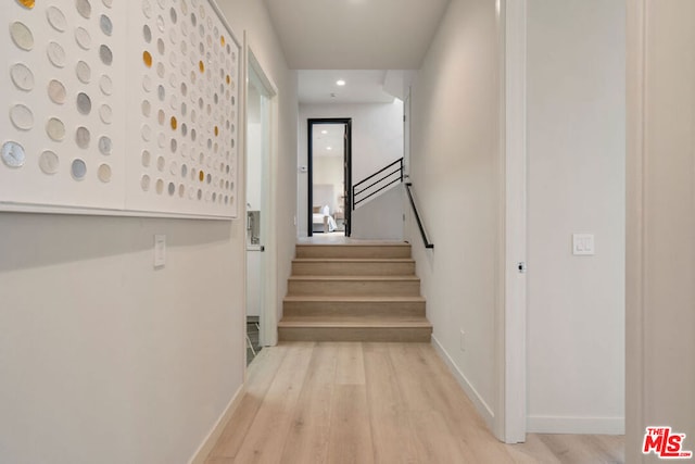 stairs featuring hardwood / wood-style flooring