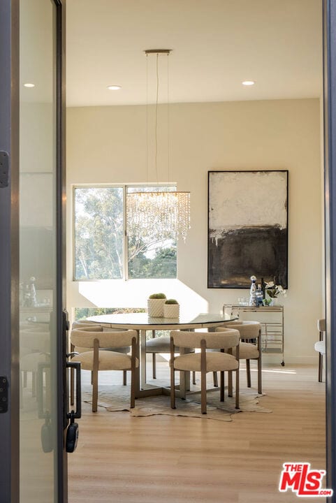 dining room featuring light hardwood / wood-style floors and an inviting chandelier