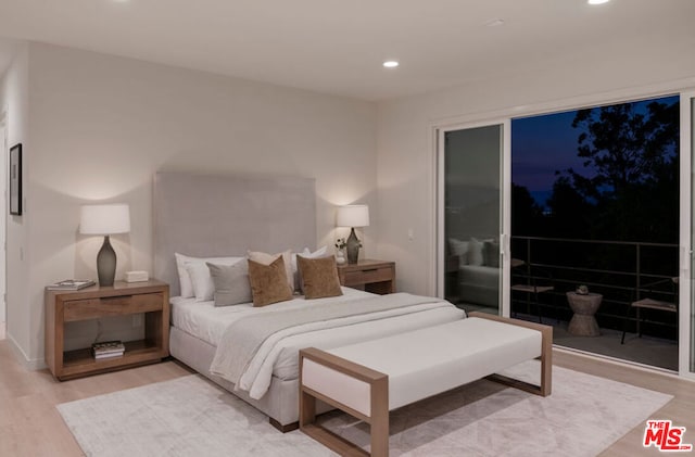 bedroom featuring light hardwood / wood-style flooring and access to exterior