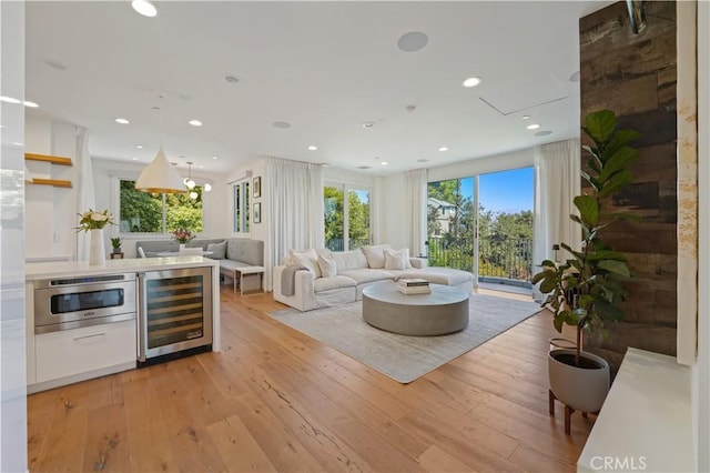 living room featuring beverage cooler and light hardwood / wood-style floors