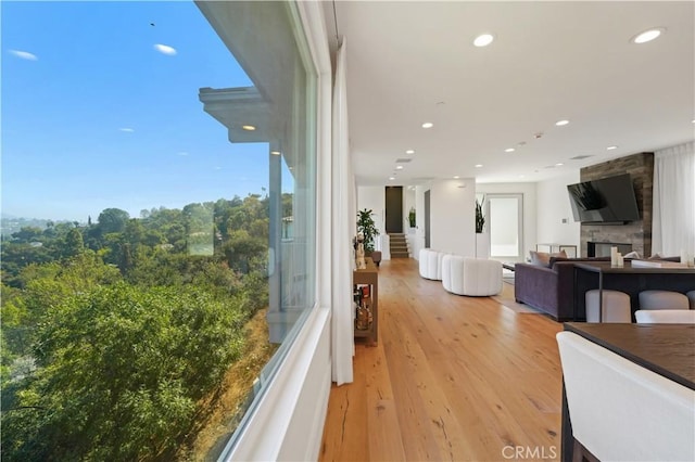 interior space with a fireplace and light hardwood / wood-style floors