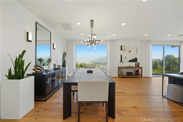 dining room featuring light hardwood / wood-style floors, an inviting chandelier, pool table, and a mountain view