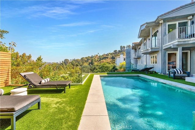 view of swimming pool featuring a yard