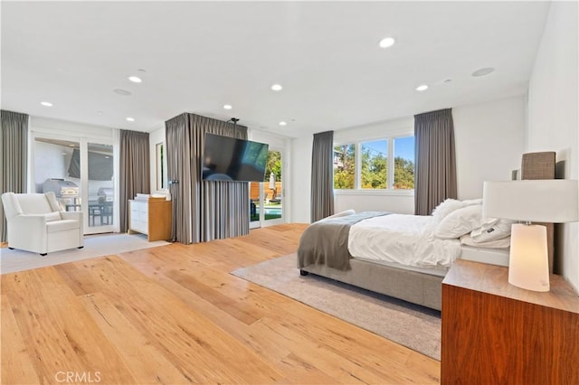 bedroom with access to outside and light hardwood / wood-style floors