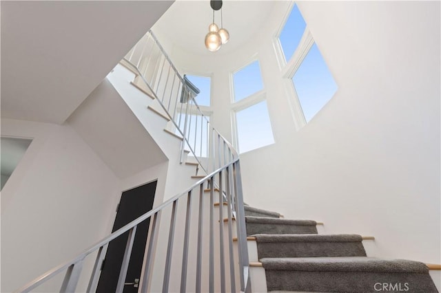 staircase with a high ceiling