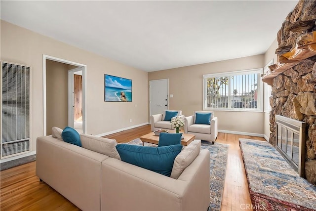 living room with light hardwood / wood-style flooring and a fireplace