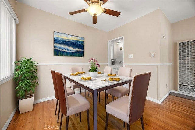 dining room featuring ceiling fan and light hardwood / wood-style flooring