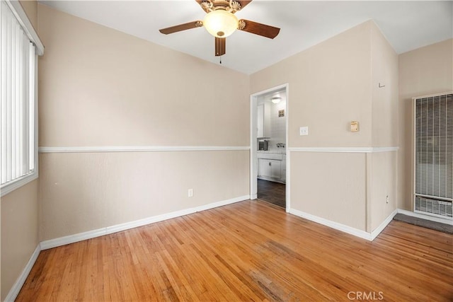 unfurnished room with ceiling fan and light wood-type flooring