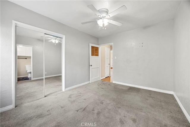 unfurnished bedroom featuring ceiling fan, ensuite bath, a closet, and light carpet