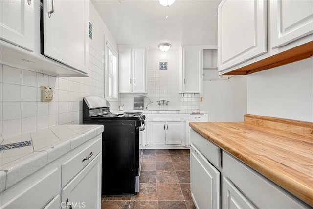 kitchen with sink, white cabinetry, electric range, and tasteful backsplash