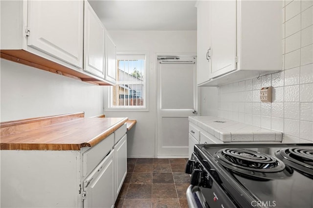 kitchen with white cabinetry and black stove