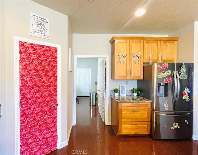 kitchen featuring light stone countertops, stainless steel fridge with ice dispenser, and dark hardwood / wood-style floors