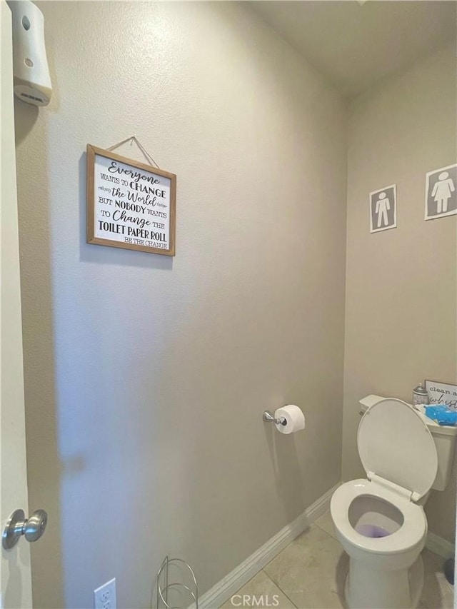 bathroom with toilet and tile patterned flooring