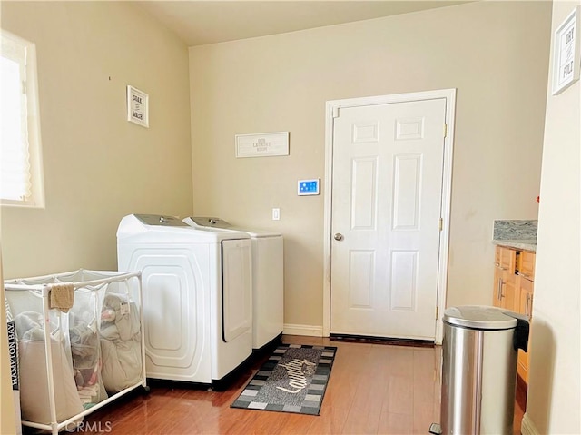 washroom featuring washing machine and dryer and dark hardwood / wood-style floors