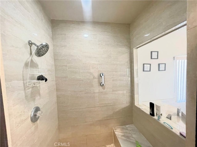 bathroom with a tile shower