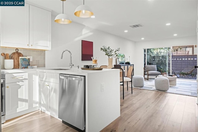 kitchen featuring dishwasher, white cabinetry, tasteful backsplash, sink, and hanging light fixtures