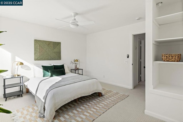 bedroom with ceiling fan and light carpet