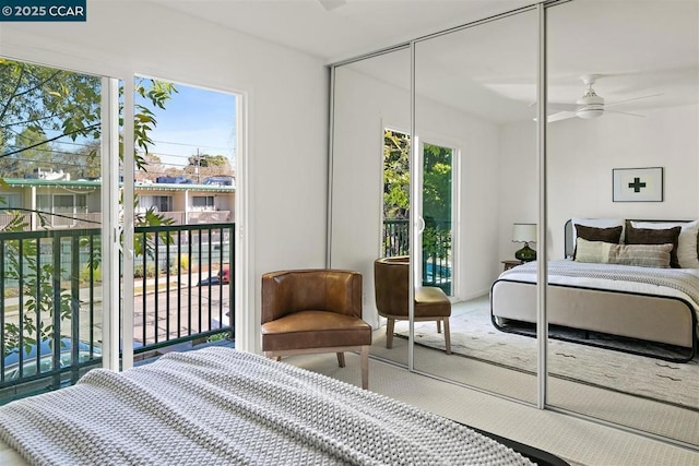 bedroom featuring ceiling fan, access to outside, a closet, and carpet flooring