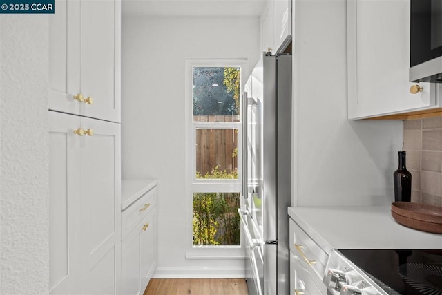 interior space with plenty of natural light and light hardwood / wood-style flooring