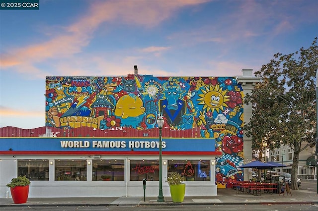 view of outdoor building at dusk