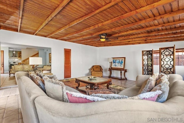 tiled living room with beamed ceiling, ceiling fan, and wood ceiling