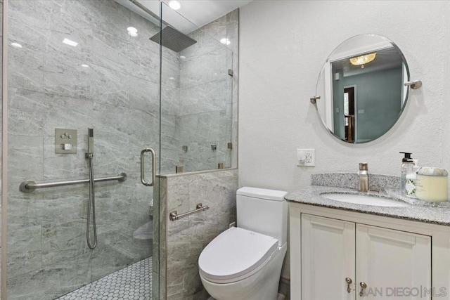 bathroom with walk in shower, vanity, and toilet