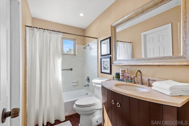 full bathroom with toilet, hardwood / wood-style floors, shower / bath combination with curtain, and vanity