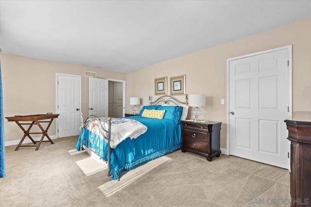 bedroom featuring light carpet