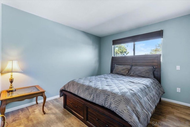 bedroom with hardwood / wood-style floors