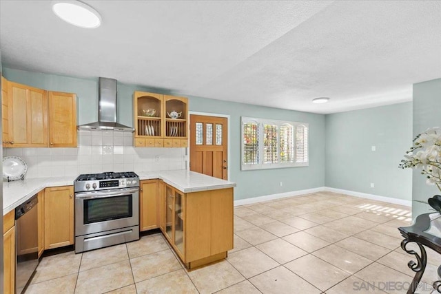 kitchen with wall chimney exhaust hood, light tile patterned flooring, tasteful backsplash, kitchen peninsula, and appliances with stainless steel finishes