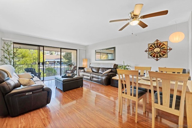 living room with wood-type flooring and ceiling fan