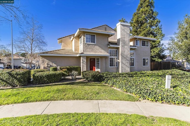 view of property featuring a front lawn