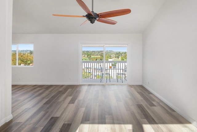 spare room featuring lofted ceiling, ceiling fan, baseboards, and wood finished floors