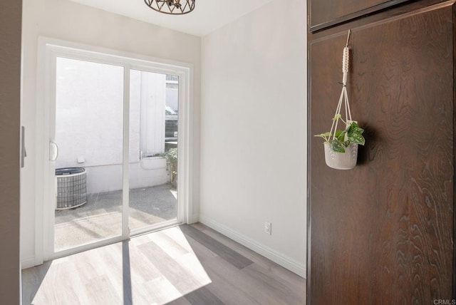 interior space featuring light wood-style floors and baseboards