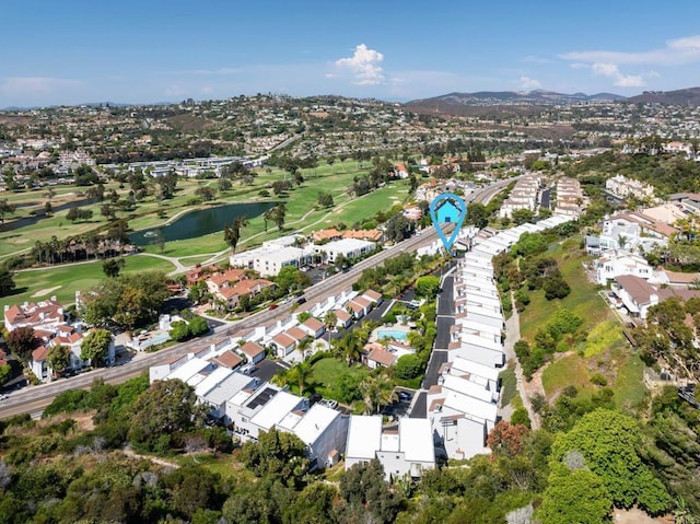 aerial view with a residential view, view of golf course, and a water view