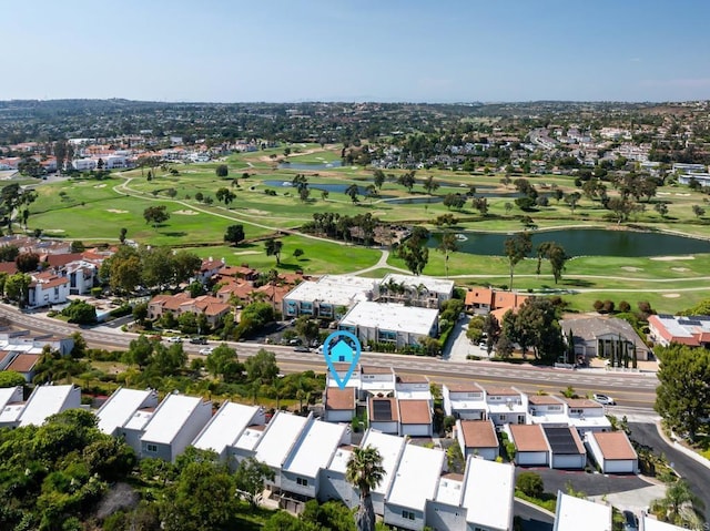 aerial view with a residential view, a water view, and golf course view