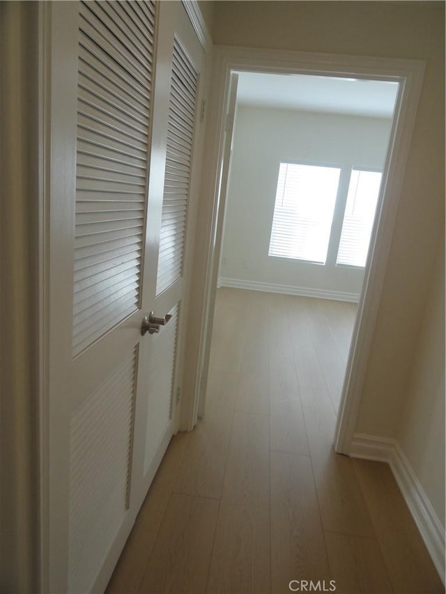 corridor with light hardwood / wood-style floors