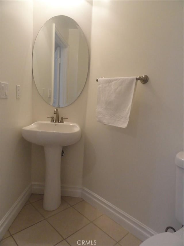 bathroom featuring toilet and tile patterned flooring