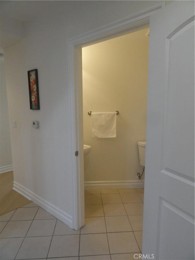 bathroom with toilet and tile patterned floors